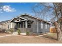 Side view of charming house with unique roofline and landscaped front yard at 2200 Fenton St, Edgewater, CO 80214