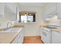 Cozy kitchen featuring bright cabinets, laminate countertops, and wood floors at 8079 Wolff St # A, Westminster, CO 80031