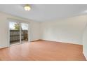 Bright living room with hardwood floors and sliding glass doors to the outside at 8079 Wolff St # A, Westminster, CO 80031