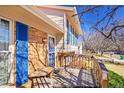 Inviting front porch with wooden bench and blue shutters, offering a warm welcome at 1244 S Argonne Cir, Aurora, CO 80017