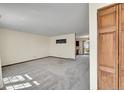 Bright and airy living room with neutral carpet and ample natural light at 1244 S Argonne Cir, Aurora, CO 80017