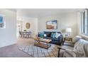 Bright and airy living room featuring a comfy couch and coffee table at 7481 Bronco Rd, Denver, CO 80221