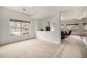 Spacious living area with bright neutral walls and carpeting that offers seamless flow and lots of natural light at 12921 E 108Th Way, Commerce City, CO 80022