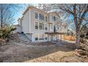 Spacious backyard featuring a covered patio and multi-level yard with mature trees at 10765 Willow Reed Ct, Parker, CO 80134