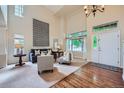 Inviting living room features soaring ceilings, a large window, and a cozy seating arrangement at 10472 Longleaf Dr, Parker, CO 80134