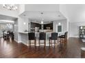 Bright open kitchen with stainless steel appliances, a large breakfast bar with pendant lighting at 9060 Ferncrest St, Firestone, CO 80504
