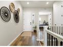 Inviting entryway with wood flooring, white trim, and decorative wall hangings at 9915 E 162Nd Pl, Brighton, CO 80602