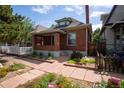 Charming brick home featuring a well-manicured lawn and inviting walkway at 132 Delaware St, Denver, CO 80223