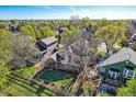 Aerial view of the backyard with a well-kept lawn, playset, wooden deck, and mature trees for shade and privacy at 10963 Bryant St, Westminster, CO 80234