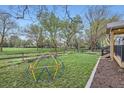 Spacious backyard featuring a patio, climbing dome, and view of trees in the landscape at 10963 Bryant St, Westminster, CO 80234