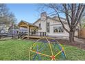 Landscaped backyard featuring a patio and a fun climbing dome for outdoor play at 10963 Bryant St, Westminster, CO 80234