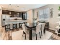 An open-concept dining area featuring modern decor, neutral tones, and seamless kitchen access at 11902 Norfolk Ct, Commerce City, CO 80022