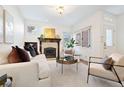 Bright living room features a fireplace, large windows, and neutral decor at 443 Garfield St, Denver, CO 80206