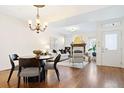 Open-concept living and dining area with hardwood floors and a cozy fireplace at 443 Garfield St, Denver, CO 80206