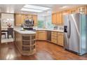 Bright eat-in kitchen with stainless steel appliances and wood cabinets at 6898 W Nova Dr, Littleton, CO 80128