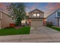Charming two-story home with a well-maintained lawn, mature tree, and two car garage at 3186 W Indian Summer Ln, Castle Rock, CO 80109