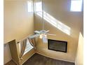 Lofted view of living room with high ceilings, large windows, and a ceiling fan at 407 Ivory Cir, Aurora, CO 80011