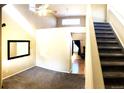 View of the living room with stairs, high ceilings and ample natural light at 407 Ivory Cir, Aurora, CO 80011