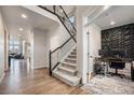 Open entryway featuring hardwood floors, staircase with wrought iron railings, and an office area at 7121 W Asbury Pl, Lakewood, CO 80227