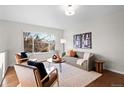 Bright living room with stylish furnishings, large windows, and modern decor at 12427 W Arkansas Ave, Lakewood, CO 80228