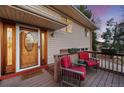 Inviting front porch featuring two red chairs, perfect for relaxing outdoors at 12427 W Arkansas Ave, Lakewood, CO 80228