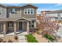 Inviting two-story home with stone accents, and a beautiful flowering tree at 21944 E Quincy Cir, Aurora, CO 80015
