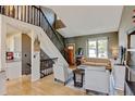 Inviting living room showcases hardwood floors, a modern staircase, and ample natural light at 8680 Apache Plume Dr, Parker, CO 80134