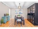 Inviting dining room with hardwood floors, stylish lighting, and elegant furnishings for memorable gatherings at 5434 S Rome St, Aurora, CO 80015
