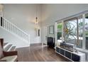 Bright foyer with hardwood floors, a staircase, and a decorative stained glass window at 5757 W Alamo Dr, Littleton, CO 80123