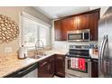 Well-equipped kitchen with granite countertops, stainless steel appliances and ample cabinet space at 2253 S Fox St, Denver, CO 80223