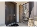 Inviting front porch with stone pillar accents and a cozy seating area at 132 Ambrose St, Erie, CO 80516