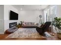 Bright living room with a fireplace, comfortable seating, and large windows at 132 Ambrose St, Erie, CO 80516