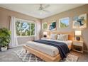 Serene main bedroom features a plush king bed, calming artwork, and abundant natural light from large windows at 12921 Grant Cir # B, Thornton, CO 80241