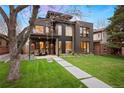 Contemporary home featuring a manicured lawn, a balcony, and outdoor seating at 2838 Tennyson St, Denver, CO 80212