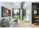 Bright living room with large windows, light wood floors, and modern decor at 2838 Tennyson St, Denver, CO 80212
