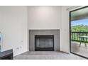 Living room showing fireplace and sliding door to balcony offering views at 2727 Folsom St # 303, Boulder, CO 80304