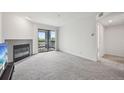 Spacious living room with cozy fireplace and access to a private balcony with scenic views at 2727 Folsom St # 303, Boulder, CO 80304