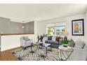 Cozy living room showcasing hardwood floors, ample seating, and lots of natural light at 13496 Alcott Way, Broomfield, CO 80020
