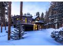 Contemporary home featuring a two-car garage and a balcony covered in winter snow at 55 Blue Flag Dr, Breckenridge, CO 80424