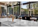 Modern kitchen and dining area with views of the forest, stylish fixtures, and an open layout at 55 Blue Flag Dr, Breckenridge, CO 80424
