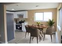 Open dining area with modern lighting, table with seating and large window at 875 S Quebec St # 25, Denver, CO 80247