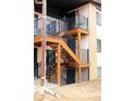Apartment building showing stairways with black metal railings and balconies with exterior entrance doors at 875 S Quebec St # 25, Denver, CO 80247