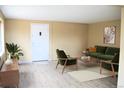 Cozy living room featuring stylish green furniture, an accent rug, and a decorative plant for a comfortable feel at 875 S Quebec St # 25, Denver, CO 80247