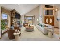 Inviting living room with stone fireplace, vaulted ceilings, and natural light at 6398 Lost Canyon Ranch Rd, Castle Rock, CO 80104