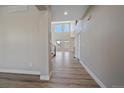 Bright entryway featuring high ceilings and elegant hardwood floors, leading into the home at 4880 River Landing Ave, Firestone, CO 80504