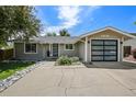 Charming single-story home with a modern garage door and drought resistant rock landscaping at 13030 King Cir, Broomfield, CO 80020