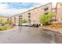 Attractive condominium exterior with multiple units, balconies, and ample parking spaces at 13456 Via Varra # 224, Broomfield, CO 80020