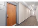 Well-lit hallway leading to unit 224, showcasing clean walls and modern carpet at 13456 Via Varra # 224, Broomfield, CO 80020