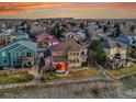 Aerial view of a two-story home with a patio and fenced backyard, nestled in a vibrant neighborhood at 9845 Glenstone Trl, Highlands Ranch, CO 80130