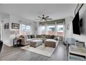 Comfortable living room with an oversized sectional sofa, ceiling fan, and large windows for natural light at 545 W 174Th Pl, Broomfield, CO 80023